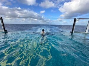 Shawn Power, Your Trusted Cruise, Tauck Tour & Africa Safari Expert in a pool onboard an Explora Journeys Cruise